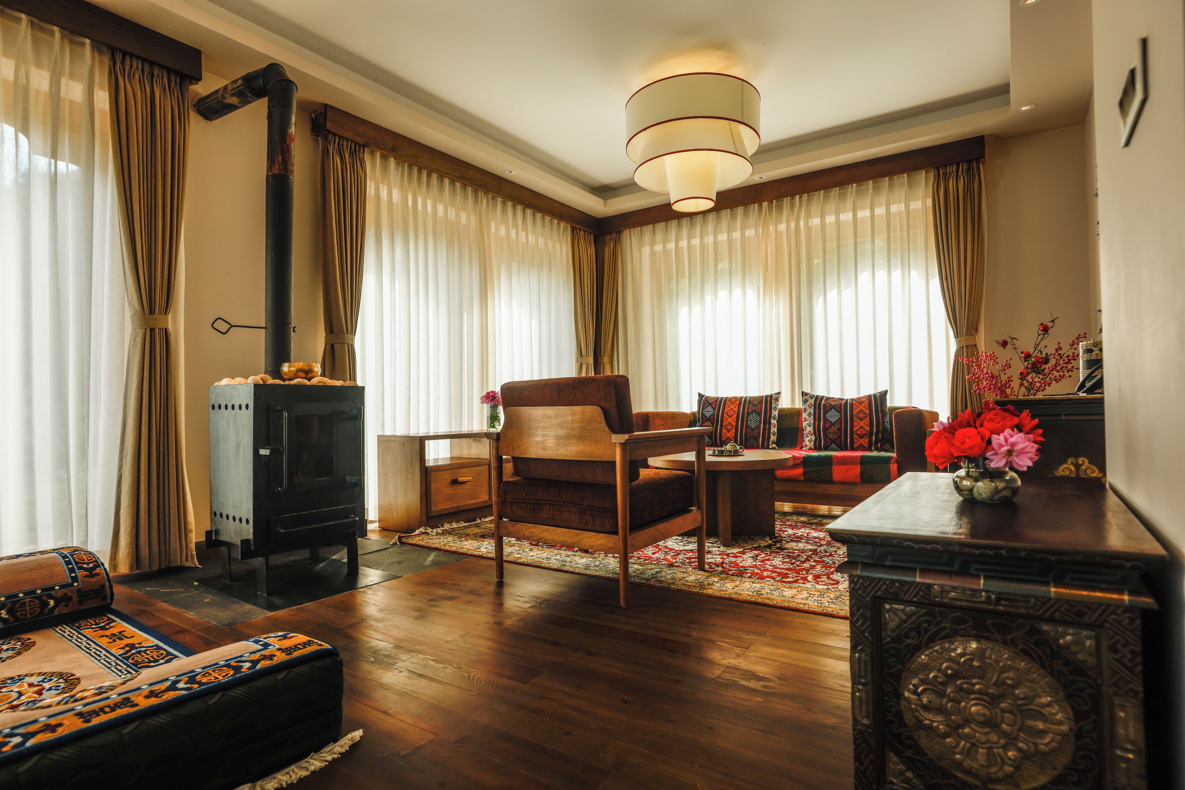A cozy living room with a fireplace, a sofa, a coffee table, and a rug.