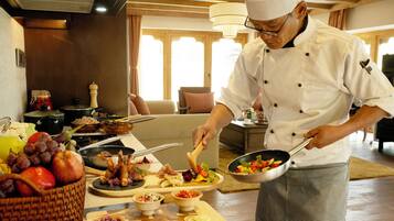 A chef preparing food in a well-lit kitchen with wooden accents and modern appliances.