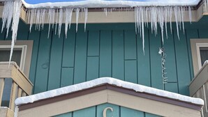 A wooden building with a snow-covered entrance and icicles hanging from the roof. - 2-bedroom 2 bath condo in Winter Park, magnificent views, hot tub, close to town (Winter Park)