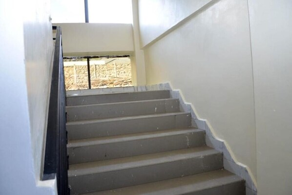 A staircase with a handrail leading to a landing.