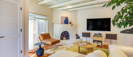 A modern living room with a sofa, coffee table, and a television.