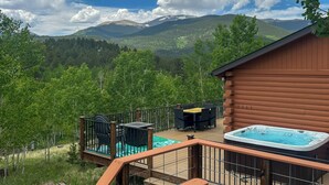 A wooden cabin with a deck, a hot tub, and a table and chairs. - Mtn-view Haven w/ Hot Tub: 9 Mi to Dtwn Bailey (Bailey)