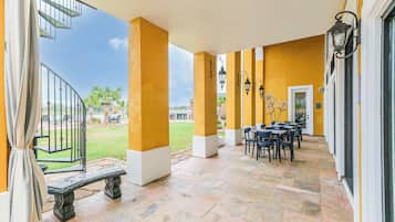 Enjoy dining or socializing in this inviting outdoor space with a patio, stairs, and comfortable seating.