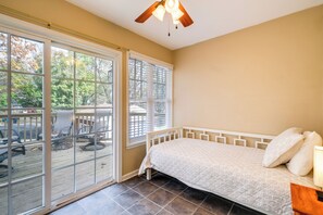 A bedroom with a bed, a ceiling fan, and large windows. - Walk to The Grandin Theatre: Roanoke Unit w/ Yard! (Roanoke)