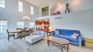 A spacious living area with a dining table, sofa, and a balcony with a view. - St Joseph River, Lake Michigan Access: Luxury Home (Saint Joseph)