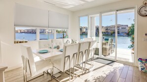 A modern dining area with a view of a body of water and buildings. - Lake & Mountain Views: Indio Oasis w/ Pool (Indio)