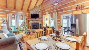 A cozy cabin interior with a dining area, fireplace, and modern kitchen. - Ridgetop Cabin in Blue Ridge! Wraparound Porch! (Blue Ridge)