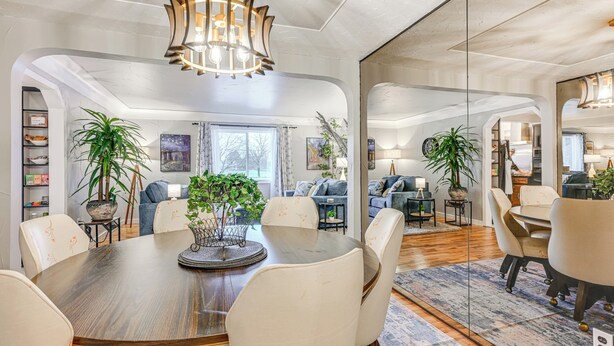 A spacious dining area with a wooden table and chairs, surrounded by sofas and potted plants. - Pet Friendly: 2 Mi to Downtown Flushing (Flushing)