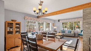 A spacious living area with a wooden dining table, chairs, a sofa, and a fireplace. - Hot Tub & Mountain Views: 5-Min to Frisco Main St. (Frisco)