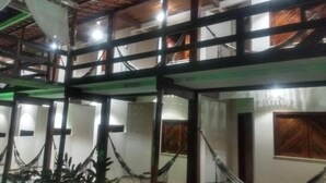 A multi-story building with a balcony and a covered outdoor area. - POUSADA PORTAL DO SOL  (Itacaré)