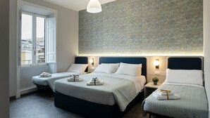 A hotel room with two beds, a large window, and a textured wall. - DoppioSei -Guest House (Rome)