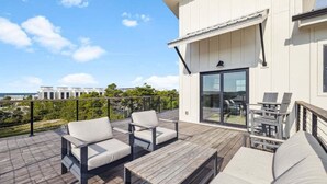 A modern outdoor deck with a sofa, chairs, and a table. - Sleeps 30! Private Heated Pool, Hot Tub, Game Room, LSV/Golf Cart, GULF VIEWS! Huge! (Santa Rosa Beach)