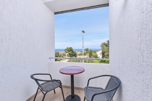 Enjoy a peaceful retreat with a balcony offering a serene view of the surrounding neighborhood.