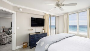 A bedroom with a bed, a TV, a dresser, and a view of the ocean. - Island Princess 604 Beachfront Luxury with Stunning Gulf Views! (Fort Walton Beach)