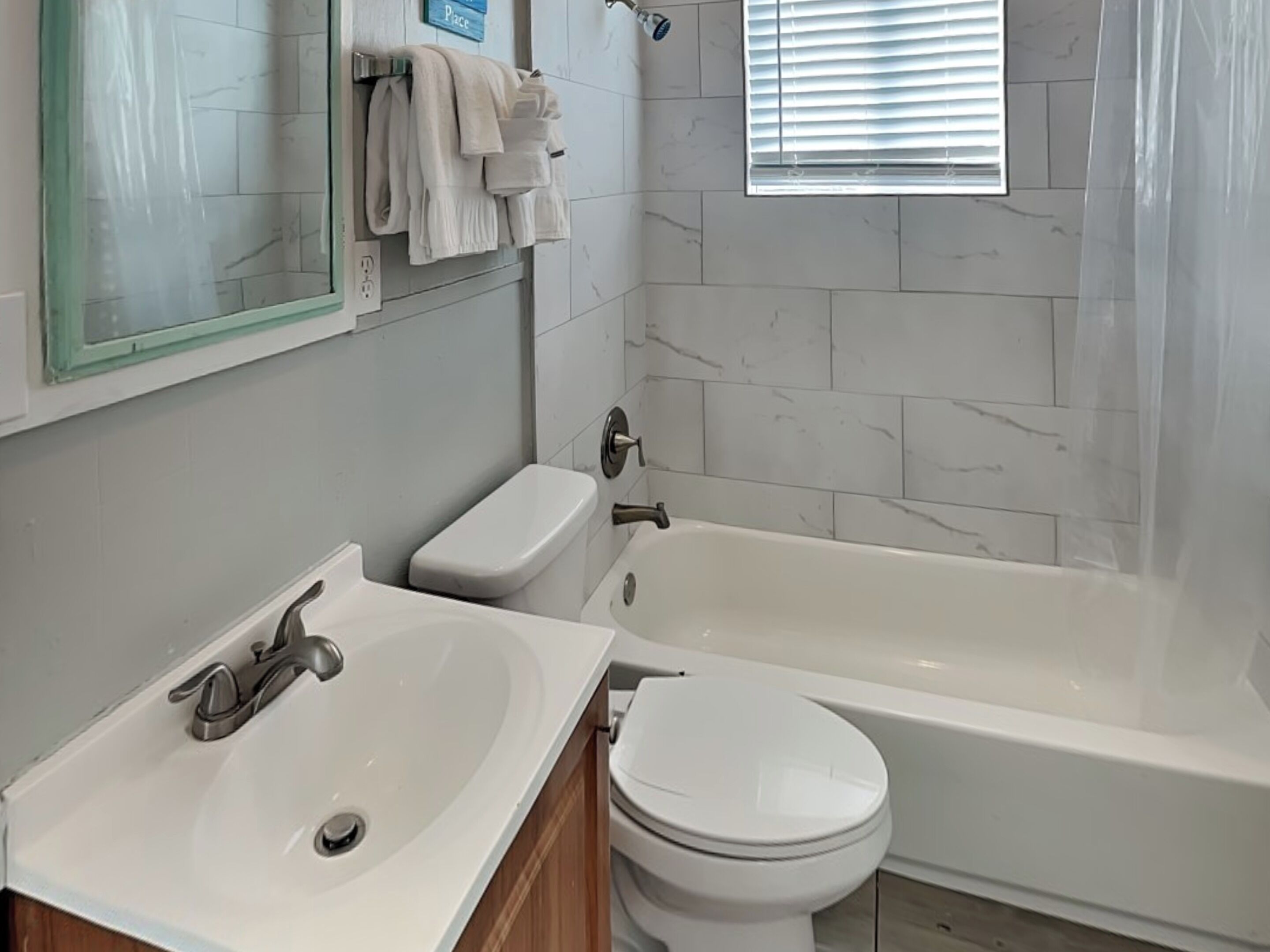 A bathroom with a sink, toilet, and bathtub.
