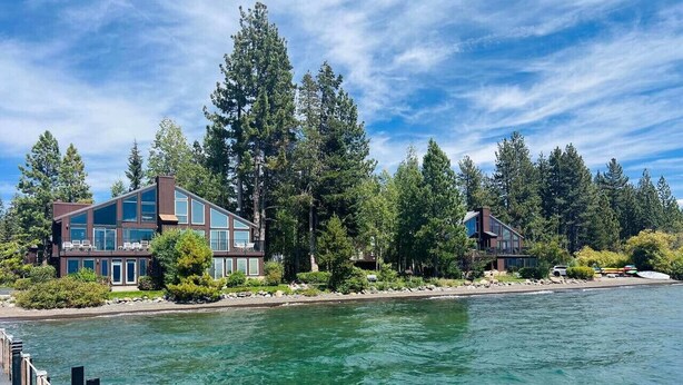 A waterfront property with modern architecture, a dock, and a forested backdrop. - Palisades and North Star Ski Apres at St. Francis (Tahoe City)