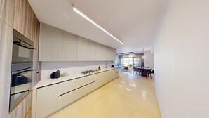 A modern kitchen with a central island, built-in appliances, and a view to the dining area. - ♦King David Residences♦Stunning 2-Bdr with Balcony & Views♦ (Jerusalem)