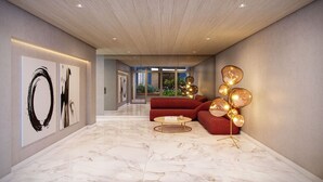 A modern interior with a marble floor, a red sofa, a gold-framed coffee table, and abstract wall art. - Studio moderno Brooklin a 230m do metrô (São Paulo)
