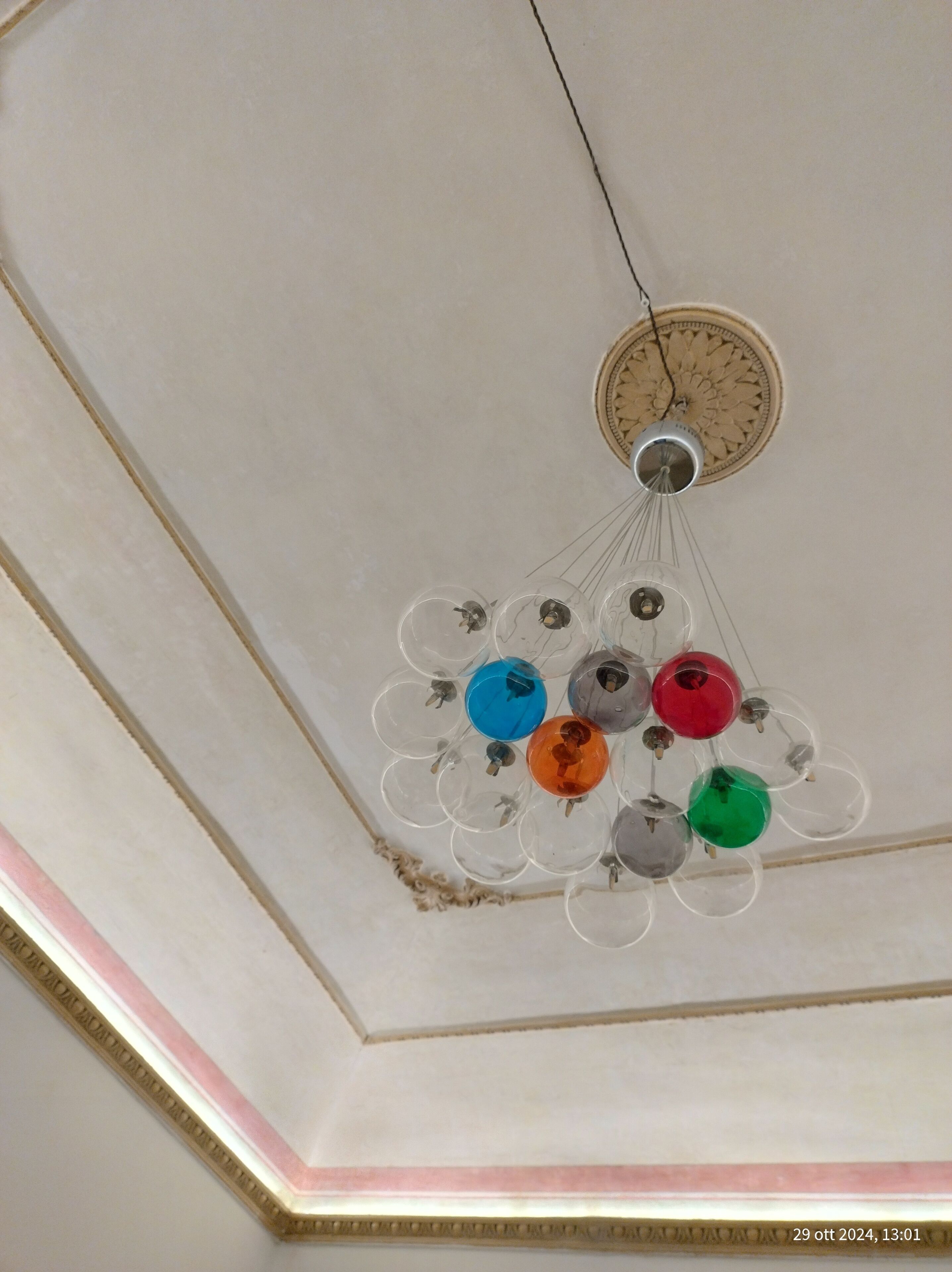 A chandelier with multiple bulbs of different colors.