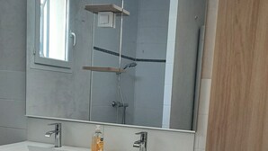 A bathroom with two sinks, a mirror, a shower, and a wooden cabinet. - Verdon region, house with terrace and garden, 3 bdrms, discount/2nd week (Régusse)