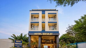 A multi-story hotel with a sign reading 'HOTEL SHIVAAY' and a signboard stating 'HOTEL SHIVAAY LUXURIOUS ROOMS | FAMILY BANQUETS'. - Hotel Shivaay  (Indore)