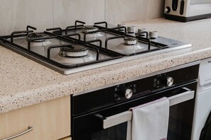 A kitchen with a gas stove, a microwave, and a dishwasher.