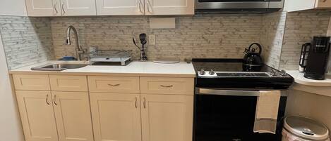 Fridge, microwave, stovetop, coffee/tea maker