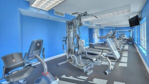 A gym with exercise equipment, a treadmill, and a mirror. - Horizon PH2 -2BR/2BA -Myrtle Beach -I/O Pools (Myrtle Beach)