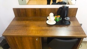 A compact wooden desk with a chair, a coffee maker, and a cup of coffee. - Ringruby Hotel, United Estate (Lekki)