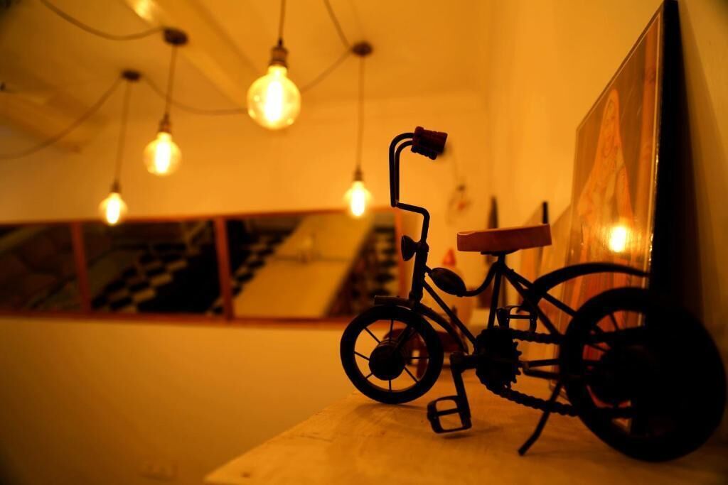 A bicycle leaning against a wall with a poster in the background.