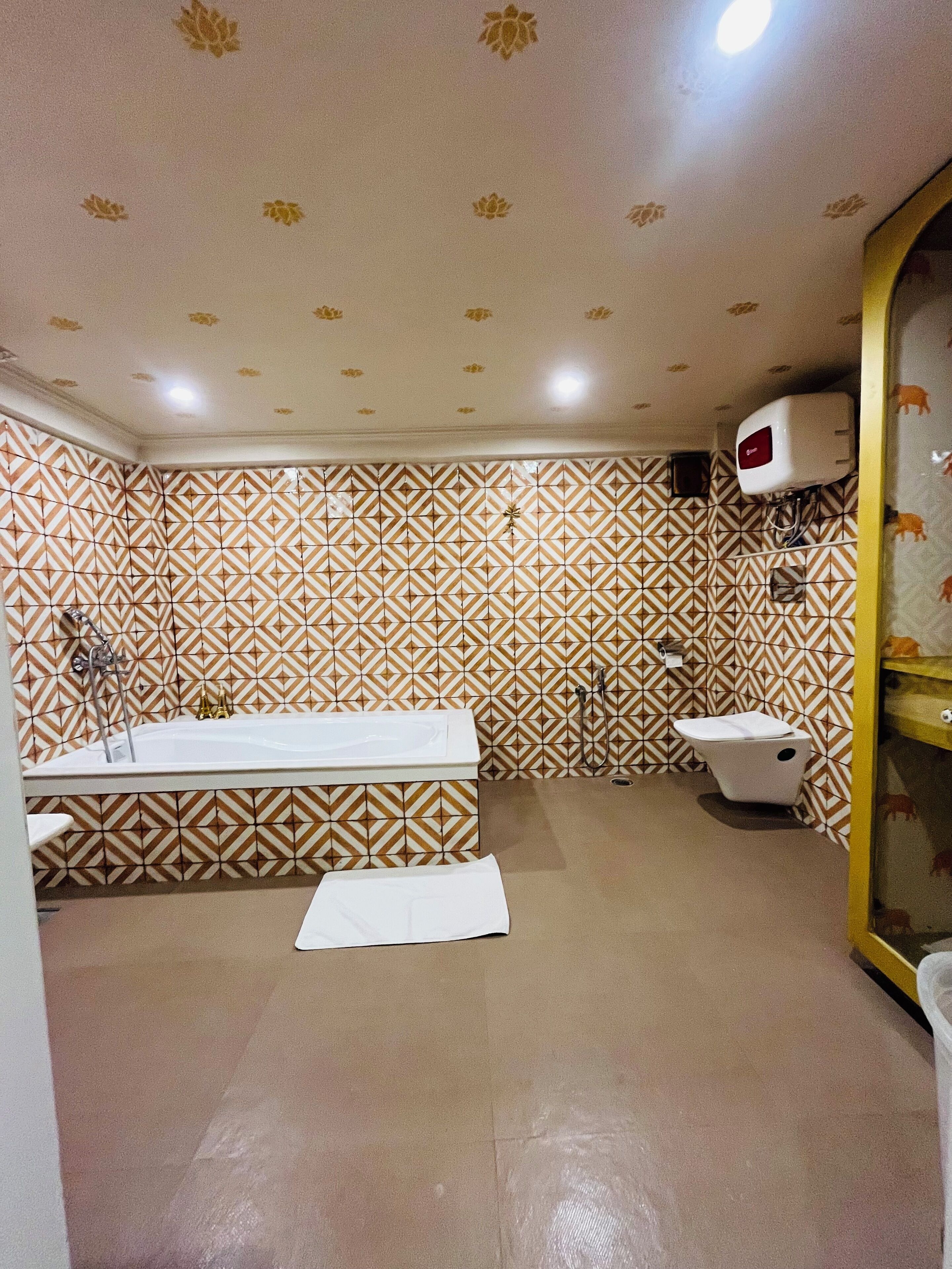 A bathroom with patterned walls, a bathtub, a toilet, and a shower.