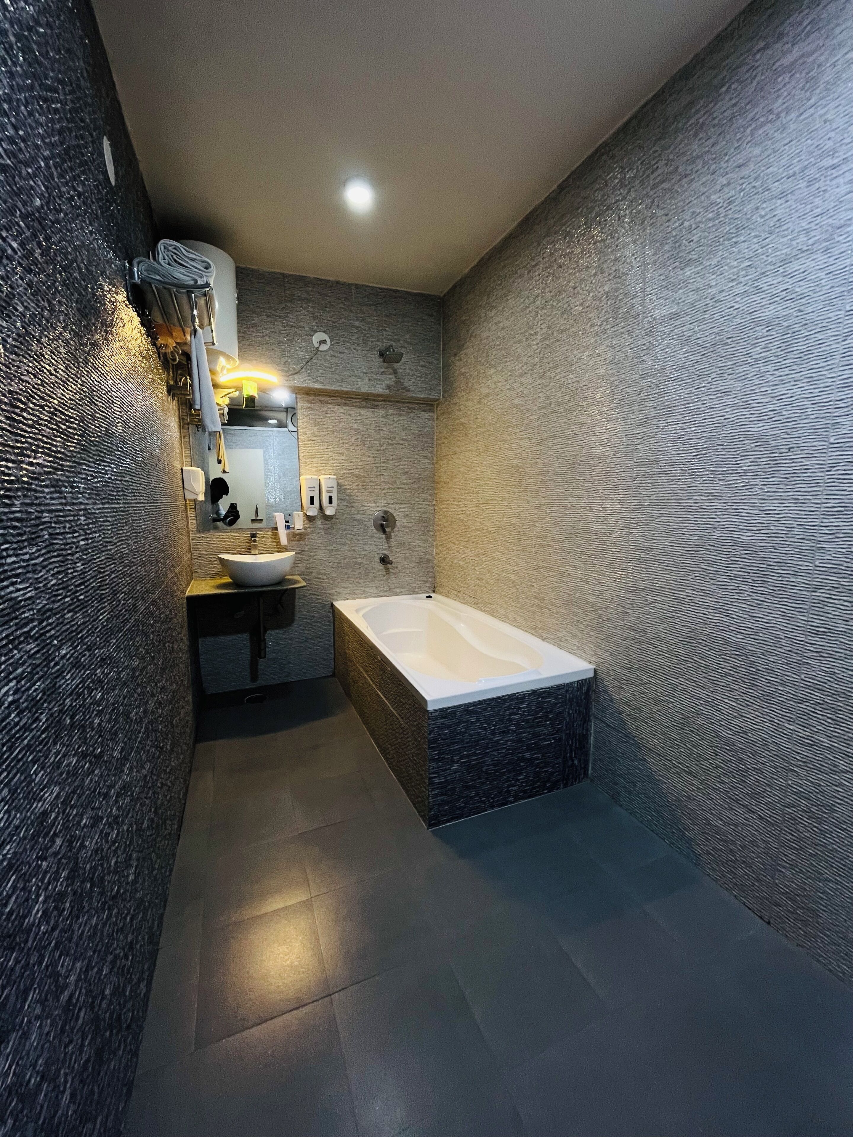A modern bathroom with a freestanding bathtub, a sink, and a mirror.