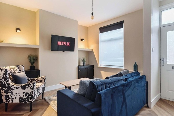 The cozy living space with a smart TV is just the start—easy access to the kitchen makes dining and relaxing a breeze.
