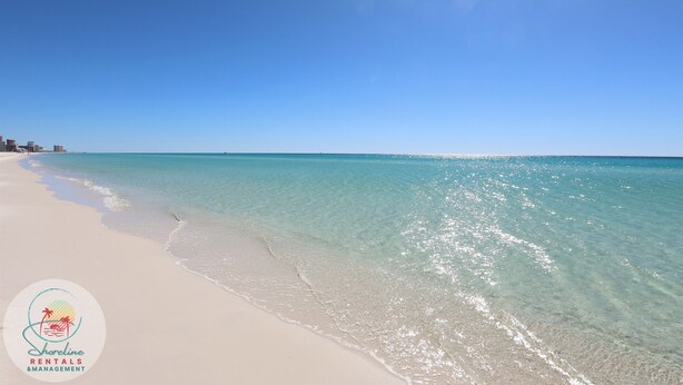 A beach with clear turquoise water and a white sandy shore. - Beachfront Condo • Rooftop Pool • Sleeps 8 (Mexico Beach)