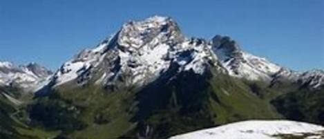 A mountain with snow-capped peaks and a clear blue sky.