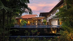 A hotel with a pool, outdoor seating, and lush greenery. - Villa Meraya by Tropiclook   (Rawai)
