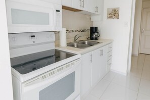 Fridge, microwave, stovetop, coffee/tea maker