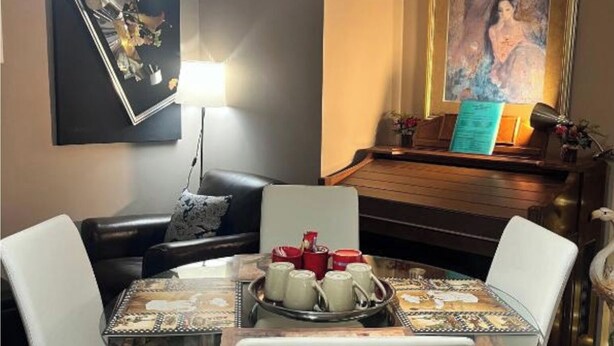A dining area with a glass table, white chairs, and a tray with teacups. - #3-Bedroom in a quiet and nice home to stay in West Edmonton Area (Edmonton)