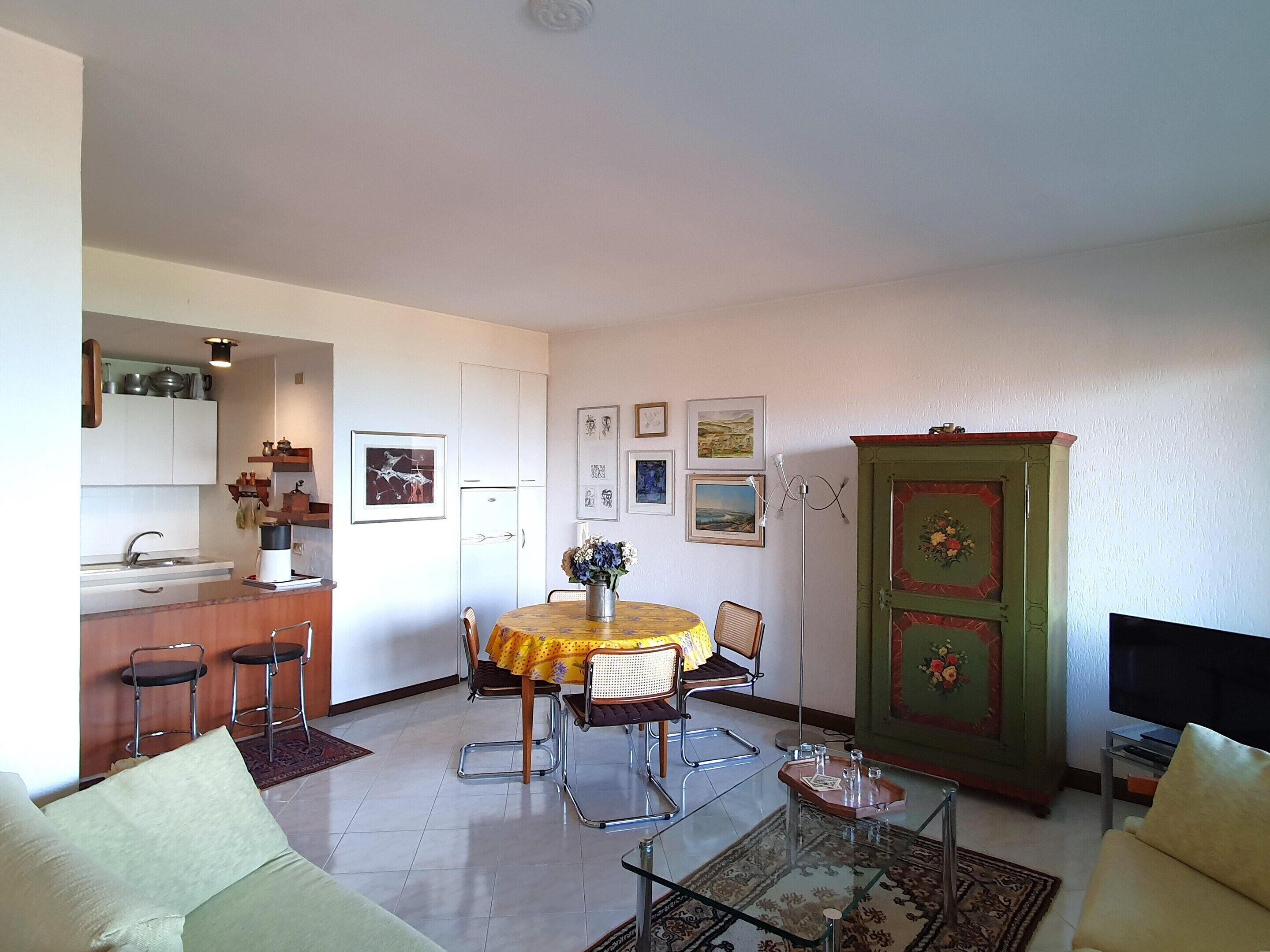A compact living space with a kitchen, dining area, and seating area.