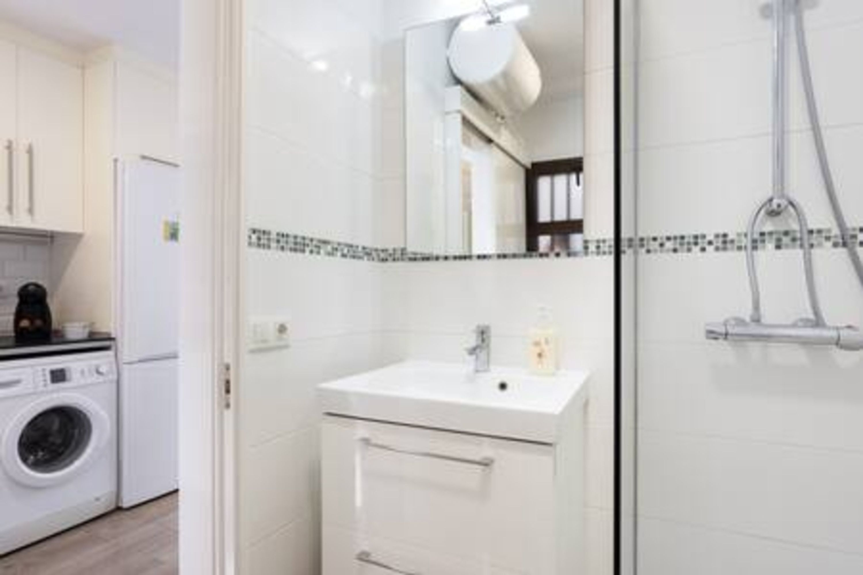 Ein modernes Badezimmer mit Waschbecken, Spiegel und Dusche.