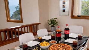 A dining table with pizza, drinks, and a potted plant. - oceanfront sanctuary michelin-adjacent & 180° view (Elk)