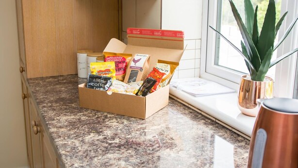 A kitchen with a box of assorted coffee and tea bags on the counter. - White Jasmine in Stroud (Stroud)