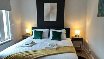 Relax in a serene space with a large bed, two nightstands, and a minimalist design.