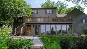A two-story house with a balcony, a staircase, and a well-maintained garden. - Astoria on Yellowstone (Sioux Falls)