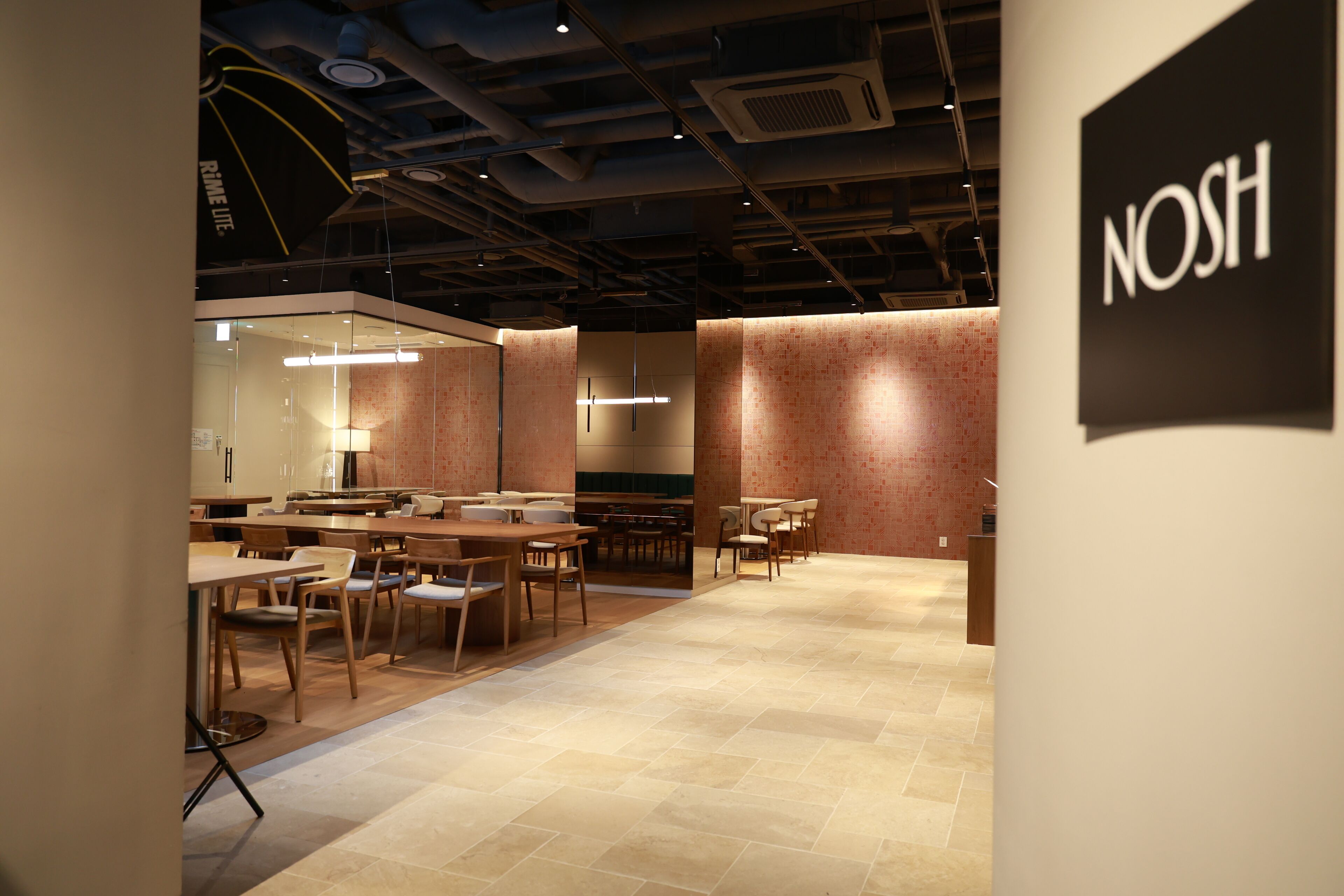 A modern interior with a dining area, tables, and chairs.