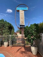 A motel sign with 'CHARLEVILLE' and 'MOTEL' written on it, and a 'VACANCY' sign below.