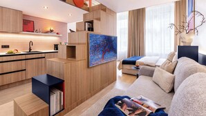 A modern living room with a sofa, a coffee table, and a bookshelf. - TurnKey | Wenceslas square Two-Level Apartment V (Praha 1)