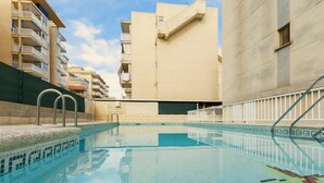 An indoor swimming pool with tiled walls and a clear blue pool. - AZUL - Cosy flat with shared swimming pool and free wifi (Daimús)