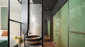 A modern bathroom with a large mirror, a bowl sink, and a vase of flowers. - Signature by M Village Danang Heritage, a brand of Modern Village Lifestyle (Da Nang)