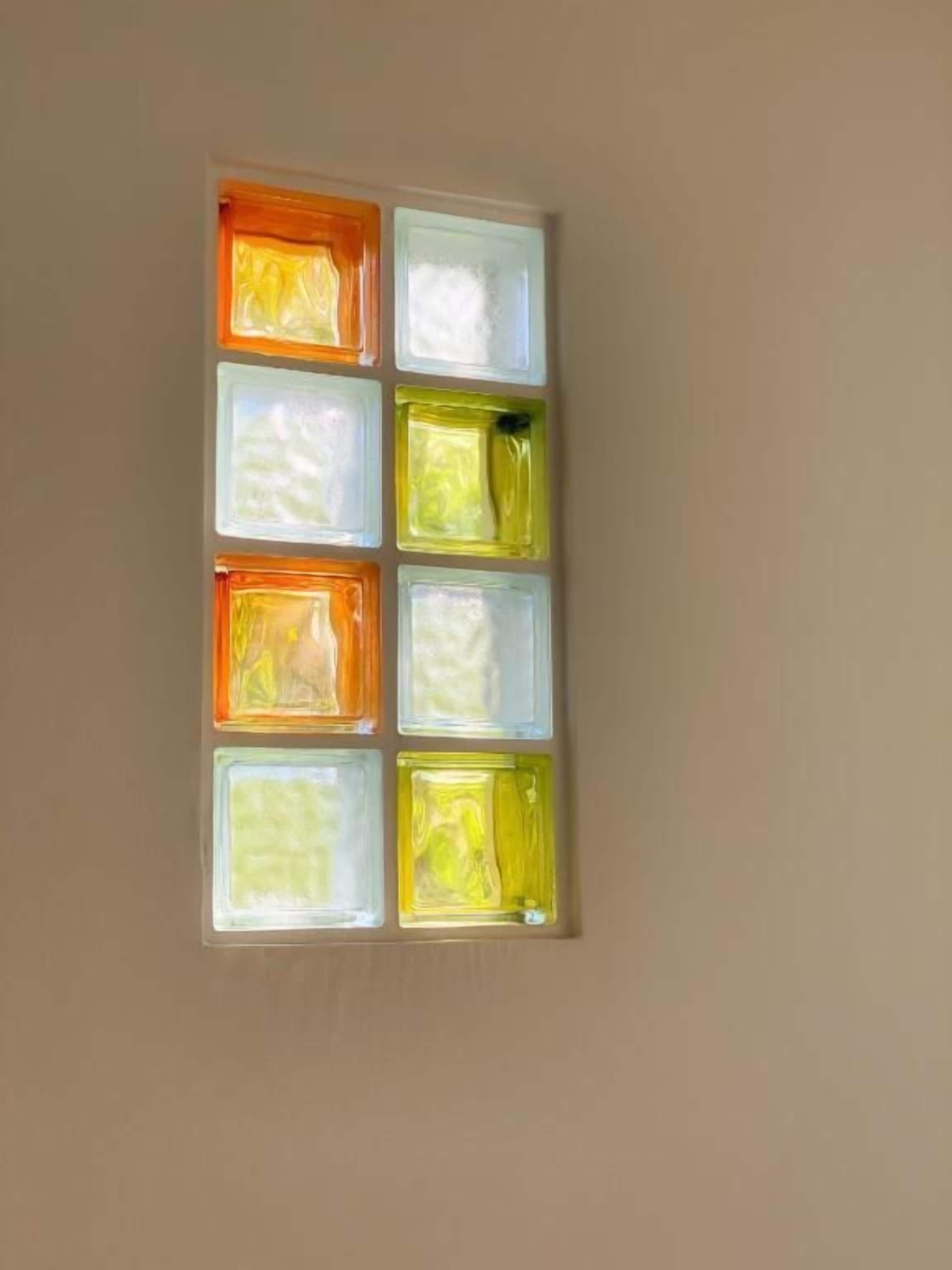 A wall with six square panels, each with a different color.